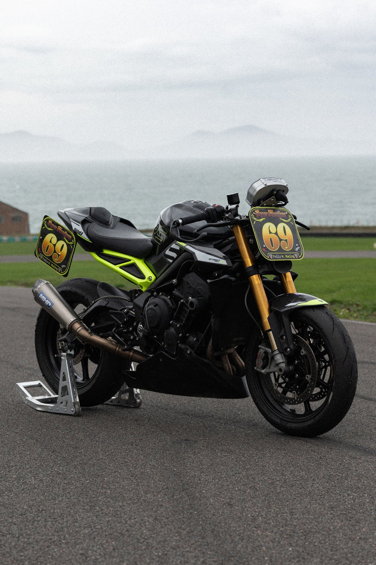 Triumph Street triple with Track / Race kit and racing number 69 stickers on circuit.