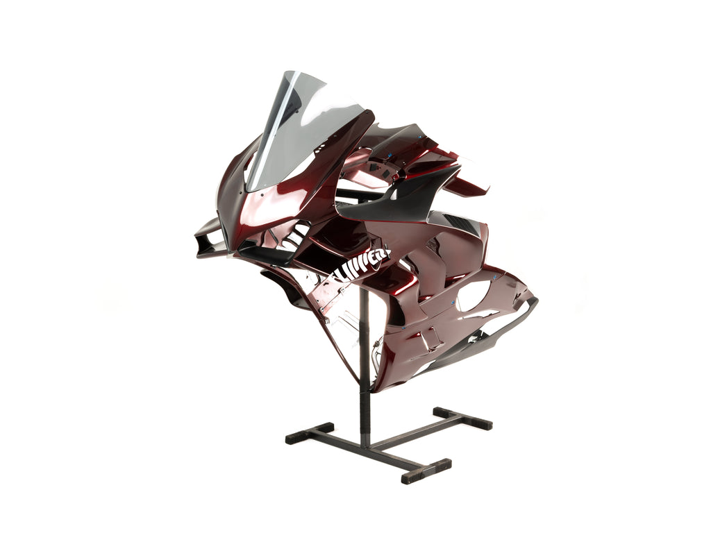 Metallic Red Ducati V4 fairings on stand against a white background